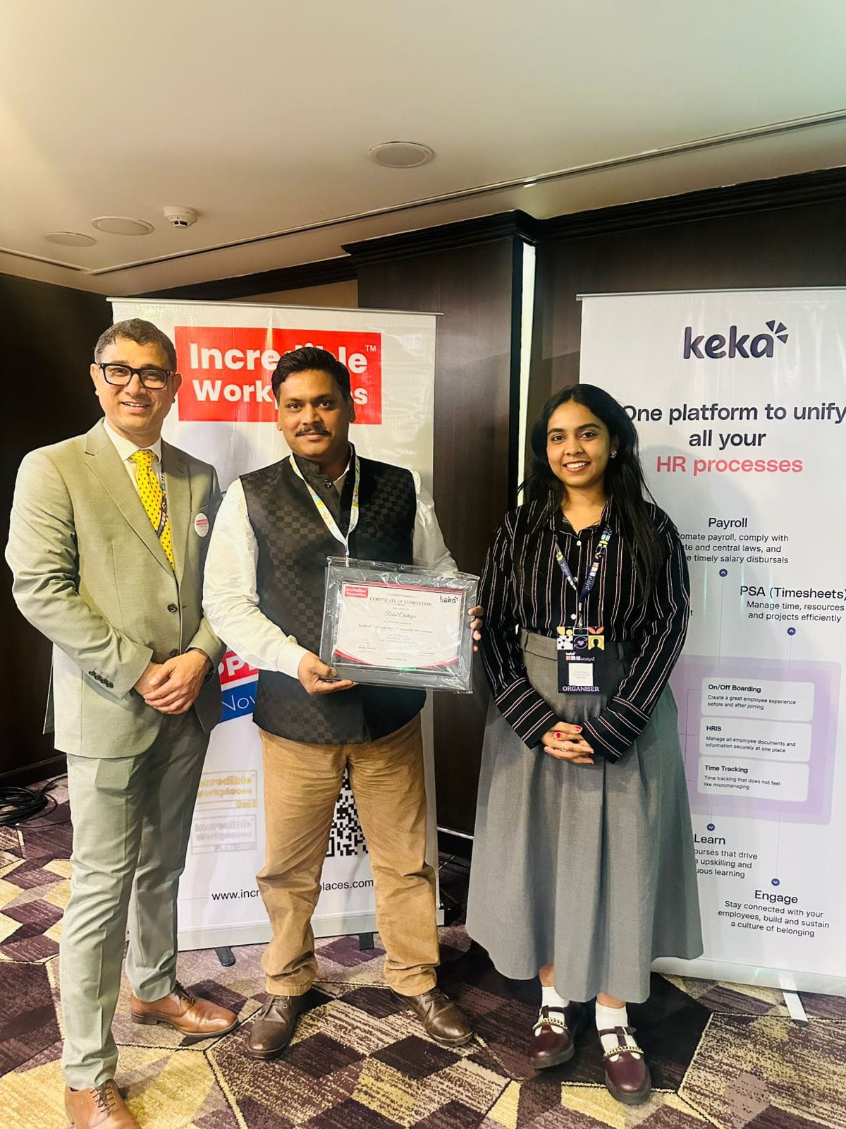 Rahul Chatterjee receiving a recognition certificate at an Incredible Workplaces event